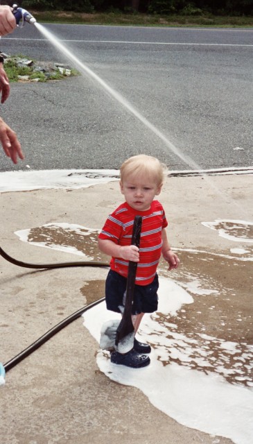 Jayden Platt helps wash the ambulance for the 4ht of July parade