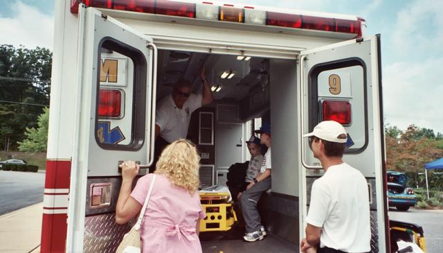 Bob Zink shows inside of ambulance to some visitors.